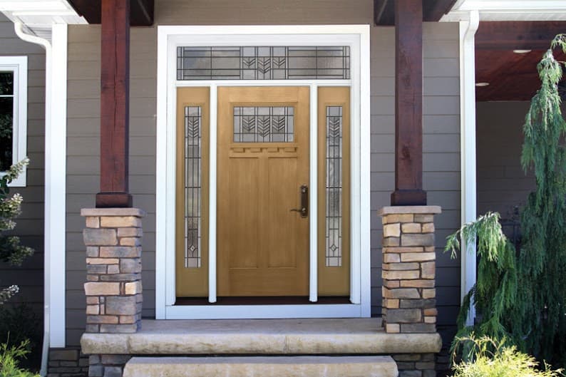 Modern transom window design above entry wood door