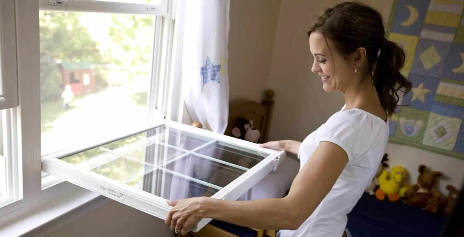 Woman adjusting bedroom window